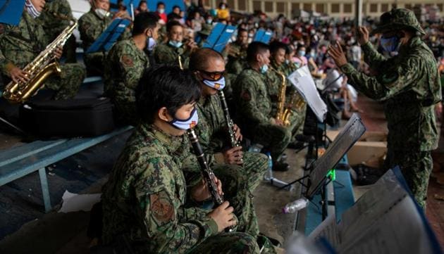 Members of the Philippine National Police wearing masks for protection against the coronavirus disease (COVID-19), play music inside a baseball stadium where thousands of stranded Filipinos wait to be transported back to their provinces through a government transportation program, in Rizal Memorial Sports Complex.(REUTERS) Members of the Philippine National Police wearing masks for protection against the coronavirus disease (COVID-19), play music inside a baseball stadium where thousands of stranded Filipinos wait to be transported back to their provinces through a government transportation program, in Rizal Memorial Sports Complex.(REUTERS)