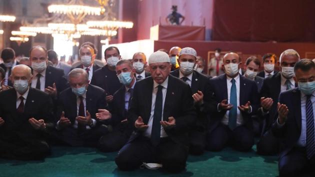 Turkey’s President Tayyip Erdogan (C) and invited guests attend Friday prayers at Hagia Sophia Grand Mosque during the official opening ceremony in Istanbul on July 24. During his 17-year rule, Erdogan has championed Islam and religious observance and backed efforts to restore Hagia Sophia’s mosque status. He had raised the issue -- popular with many pious AKP-voting Turks -- during local elections last year, Reuters reported. (Mustafa Kamaci / Turkish Presidential Press service / AFP) Turkey’s President Tayyip Erdogan (C) and invited guests attend Friday prayers at Hagia Sophia Grand Mosque during the official opening ceremony in Istanbul on July 24. During his 17-year rule, Erdogan has championed Islam and religious observance and backed efforts to restore Hagia Sophia’s mosque status. He had raised the issue -- popular with many pious AKP-voting Turks -- during local elections last year, Reuters reported. (Mustafa Kamaci / Turkish Presidential Press service / AFP)