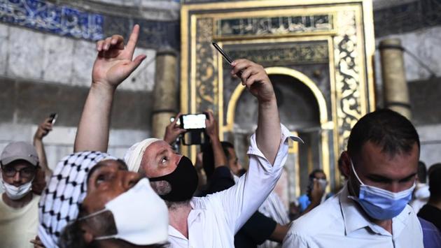 People take pictures inside the Hagia Sophia Grand Mosque on July 24. The conversion from a museum to a mosque has triggered fierce criticism from church leaders, who said the conversion to exclusively Muslim worship risked deepening religious divisions. Turkey says the site will remain open for visitors and its Christian artworks protected, Reuters reported. (Omer Kuscu / AP) People take pictures inside the Hagia Sophia Grand Mosque on July 24. The conversion from a museum to a mosque has triggered fierce criticism from church leaders, who said the conversion to exclusively Muslim worship risked deepening religious divisions. Turkey says the site will remain open for visitors and its Christian artworks protected, Reuters reported. (Omer Kuscu / AP)