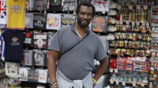 Paul Tomo poses for a photo in front of a souvenir stand in Westminster in London on July 22. “Two things, if we really needed them why weren't they introduced in the beginning. They gave a deadline before they implemented it which gives you a clear indication to question what you are being told because its clearly for control purposes not for your protection whatsoever,” Tomo told AP. (Kirsty Wigglesworth / AP) Paul Tomo poses for a photo in front of a souvenir stand in Westminster in London on July 22. “Two things, if we really needed them why weren't they introduced in the beginning. They gave a deadline before they implemented it which gives you a clear indication to question what you are being told because its clearly for control purposes not for your protection whatsoever,” Tomo told AP. (Kirsty Wigglesworth / AP)