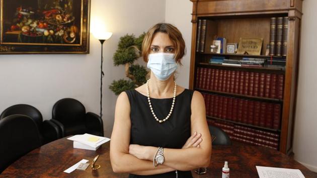 Notary Ilaria Virginia Infelisi poses with a surgical mask in her studio in Rome, on July 21. “In my study, I'm very unpermissive. I ask everyone to wear it during the drafting of contracts even if there is a lot of space and everything is disinfected after each meeting. We ask it politely because I believe it is fundamentally a sign of courtesy and mutual respect.” (Ricardo De Luca / AP) Notary Ilaria Virginia Infelisi poses with a surgical mask in her studio in Rome, on July 21. “In my study, I'm very unpermissive. I ask everyone to wear it during the drafting of contracts even if there is a lot of space and everything is disinfected after each meeting. We ask it politely because I believe it is fundamentally a sign of courtesy and mutual respect.” (Ricardo De Luca / AP)
