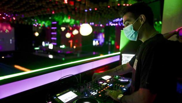 A DJ performs in a discotheque in Madrid, Spain, early Saturday, July 25, 2020. Nightlife is becoming the new target of Spanish authorities attempting to contain a spike in coronavirus infections since the country ended a lockdown. The Catalonia regional government has shut nightlife venues in Barcelona, and on Friday officials in Madrid said they were considering a similar step. (AP) A DJ performs in a discotheque in Madrid, Spain, early Saturday, July 25, 2020. Nightlife is becoming the new target of Spanish authorities attempting to contain a spike in coronavirus infections since the country ended a lockdown. The Catalonia regional government has shut nightlife venues in Barcelona, and on Friday officials in Madrid said they were considering a similar step. (AP)