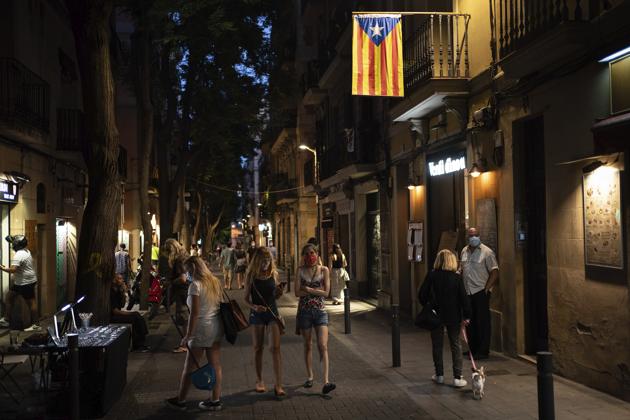People walk at night in Gracia neighbourhood in Barcelona, Spain, Friday, July 24, 2020. Health authorities in the northeastern region of Catalonia have ordered nightclubs to be fully closed and bars and restaurant in Barcelona to shut down by midnight in an effort to stem the spread of the new coronavirus. (AP) People walk at night in Gracia neighbourhood in Barcelona, Spain, Friday, July 24, 2020. Health authorities in the northeastern region of Catalonia have ordered nightclubs to be fully closed and bars and restaurant in Barcelona to shut down by midnight in an effort to stem the spread of the new coronavirus. (AP)