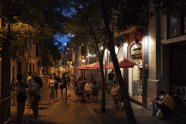 People gather outside a restaurant at night in Gracia neighbourhood in Barcelona, Spain, Friday, July 24, 2020. (AP) People gather outside a restaurant at night in Gracia neighbourhood in Barcelona, Spain, Friday, July 24, 2020. (AP)