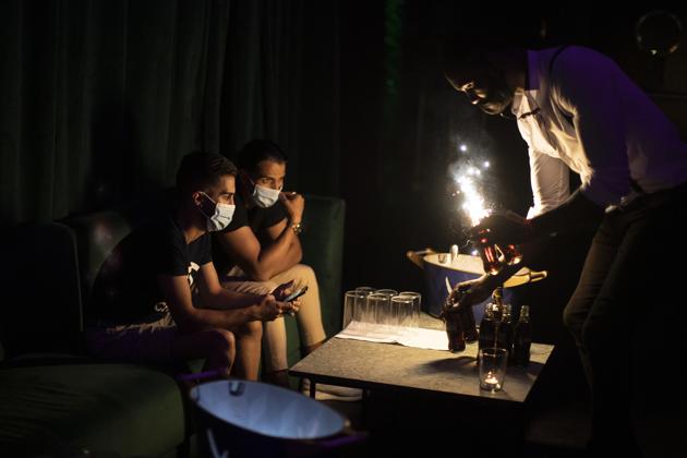 People wearing face masks to prevent the spread of coronavirus gather in a discotheque in Madrid, Spain, early Saturday, July 25, 2020. \ (AP) People wearing face masks to prevent the spread of coronavirus gather in a discotheque in Madrid, Spain, early Saturday, July 25, 2020. \ (AP)