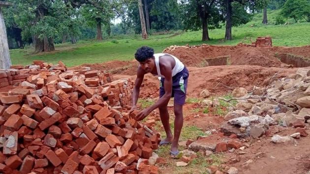 The construction of a demolished school in a village started a week ago with the help of local villagers and Maoists who have surrendered.(HT Photo)