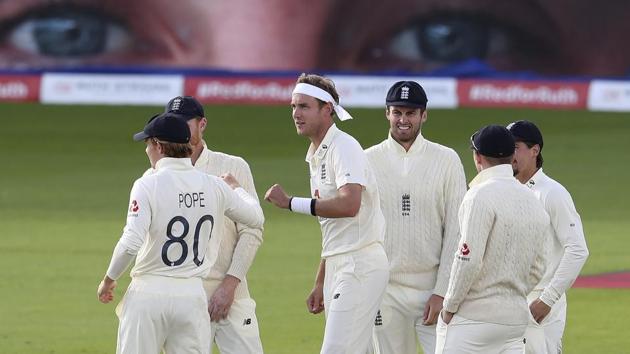 England's Stuart Broad, center, celebrates with teammates the dismissal of West Indies' John Campbell during the third day of the third cricket Test match between England and West Indies at Old Trafford in Manchester, England, Sunday, July 26, 2020. (AP) England's Stuart Broad, center, celebrates with teammates the dismissal of West Indies' John Campbell during the third day of the third cricket Test match between England and West Indies at Old Trafford in Manchester, England, Sunday, July 26, 2020. (AP)