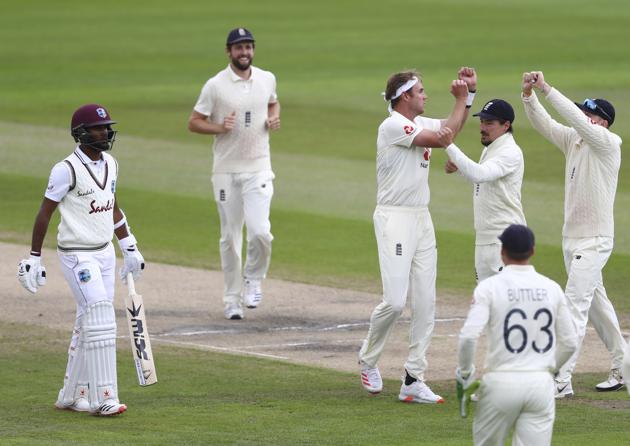 England's Stuart Broad, third right, celebrates the dismissal of West Indies' Kraigg Brathwaite, left, during the second day of the third cricket Test match between England and West Indies at Old Trafford in Manchester, England, Saturday, July 25, 2020. (Michael Steele/Pool via AP) (AP)