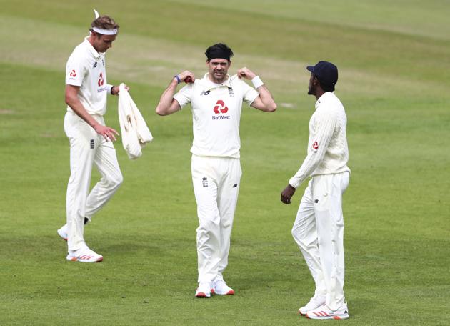 England's James Anderson, center, with teammates Stuart Broad, left, and Jofra Archer during the second day of the third cricket Test match between England and West Indies at Old Trafford in Manchester, England, Saturday, July 25, 2020. (Michael Steele/Pool via AP) (AP)
