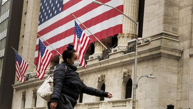 A pedestrian wearing a mask in the wake of the coronavirus pandemic walks past the New York Stock Exchange (NYSE) in New York.(Reuters File Photo)