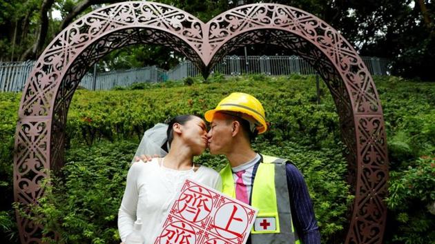 Elaine and Henry pose for a photograph after getting married on August 4, 2019. Arrested at a pro-democracy protest, the couple were kept in different cells at the police station, separated by a long corridor and a large wall. “We couldn’t see each other. But if we yelled loud enough, we could listen to each other’s voices,” Elaine told Reuters. (Kim Kyung-Hoon / REUTERS)