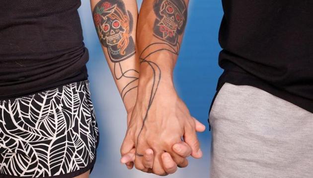 Elaine and Henry hold hands with matching tattoos on, as they pose for a photo, a day before their court ruling on July 23. Nearly a year after they were first arrested, the newlyweds were tried on charges of rioting, an offence carrying a penalty of up to 10 years in jail. (Tyrone Siu / REUTERS)