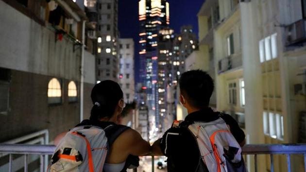 Elaine and Henry are seen together in front of high-rise buildings, a day before their court ruling on July 23. The prosecution said in court that even though there was no evidence showing that the couple was present at the point where the rioting took place, they shared the goals of those participating in the rioting. They also faced an additional charge of possessing a radio apparatus without a valid license, Reuters reported. (Tyrone Siu / REUTERS)