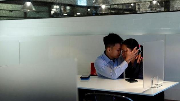 Elaine To breaks down as she is hugged by her husband Henry Tong at a restaurant in Hong Kong on July 24. They both faced rioting charges after being arrested at an anti-extradition bill protest. Since June last year, over 9,000 people have been arrested during such protests, which saw millions of people demanding to retrace the classification of protesters as “rioters” and full democracy in the Chinese-ruled territory among other demands. (Tyrone Siu / REUTERS)