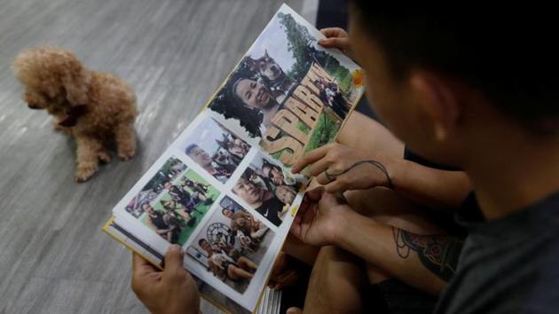 Elaine and Henry look over a personalised photo book at their gym on June 25. For Valentine’s Day this year, Henry gave Elaine this photo book which holds memories of their life together. However, the book doesn’t mention the 50 hours that Henry and Elaine spent in jail in July last year, just four days before their wedding. (Tyrone Siu / REUTERS)