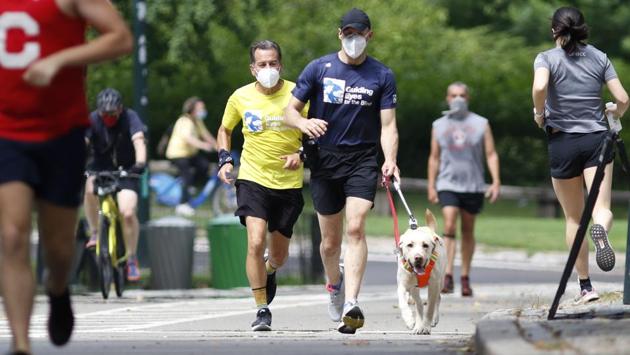 Pandemic-required social distancing rules can make exercising a challenge for blind runners like Panek, who in the past has needed a volunteer guide tethered to him. But, Panek says, using a guide dog allows blind runners like himself to keep exercising in an era of virus-related restrictions that have closed gyms.  (AP Photo/Kathy Willens) 