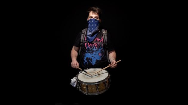 Tel Bluver, 32, poses for a photo with his drum as he readies to participate in a protest in Jerusalem on July 23. According to an AP report, thousands now taking to the streets several times a week come from all walks of life and with unemployment surging to record numbers they demand a reckoning from the leader. (Oded Balilty / AP)