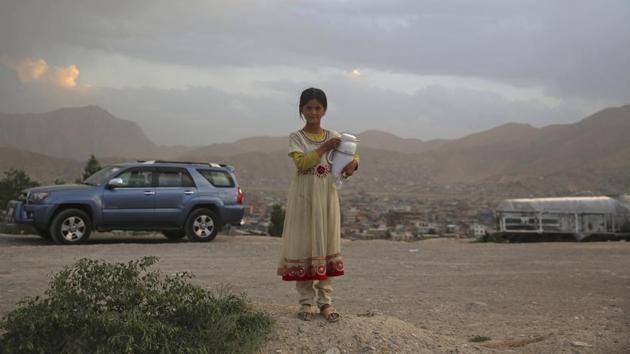 An Afghan girl poses for a photograph as she sells tea on hilltop in Kabul, Afghanistan.(AP) An Afghan girl poses for a photograph as she sells tea on hilltop in Kabul, Afghanistan.(AP)