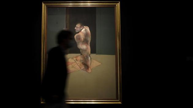 A man walks past a painting by Francis Bacon called 'Study for Portrait of John Edwards' at Sotheby's auction rooms in London, Thursday, July 23, 2020. (AP Photo/Kirsty Wigglesworth)