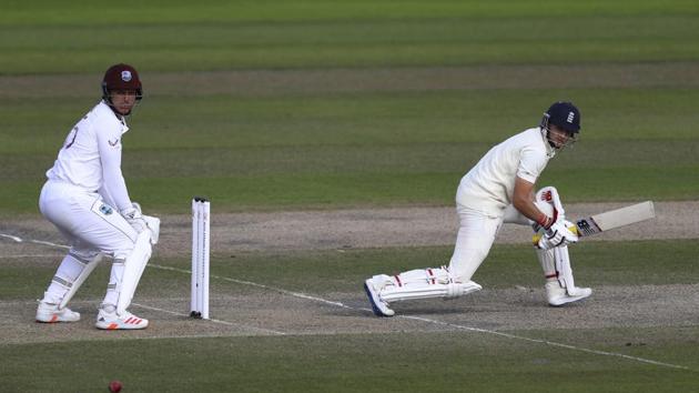 England's captain Joe Root, right, plays a reverse sweep during the third day of the third cricket Test match between England and West Indies. (AP)
