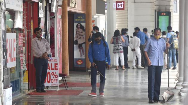 A health worker chemically disinfects the premises of the inner circle at Connaught Place in New Delhi on July 25. Delhi recorded its first coronavirus case on March 2 this year, over a month after India recorded its first case on January 30 in Kerala. With the exception of activities barred by the centre, much of daily life has now resumed in the capital with due precautions. (Sonu Mehta / HT Photo)