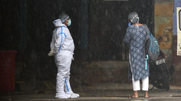 A hospital staff waits outside the coronavirus ward at I.D. & B.G. Hospital in Kolkata on July 27. Bloomberg reported that India is only trailing the US and Brazil now in the number of confirmed infections, but its growth in new cases is the fastest. (Samir Jana / HT Photo)