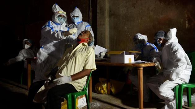 A medical professional in PPE coverall collects swab sample from a man to test for Covid-19 at Gobindapur in Kolkata, on July 23. The Union Health Ministry shared in its morning health bulletin that with a single-day jump of 47,708 COVID-19 cases, India’s caseload climbed to 14,83,156 on July 28. (Samir Jana / HT Photo)