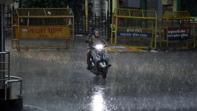 A police personnel rides a scooter during heavy rainfall, in Lucknow. (ANI file photo) A police personnel rides a scooter during heavy rainfall, in Lucknow. (ANI file photo)