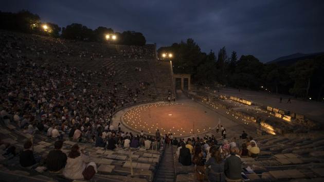 Spectators sit at the ancient theater of Epidaurus, during a concert, on Friday, July 17, 2020. (AP Photo/Petros Giannakouris)