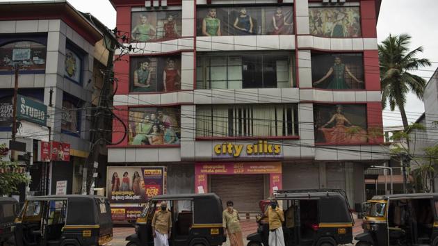 Auto rickshaw drivers wait for customers outside a clothing store that was closed after being declared part of COVID-19 containment zone in Kochi, Kerala state, India, Saturday, July 18, 2020. Experts say India is likely to witness a series of peaks as the coronavirus infection spreads in rural areas. (AP Photo/R S Iyer) (AP) Auto rickshaw drivers wait for customers outside a clothing store that was closed after being declared part of COVID-19 containment zone in Kochi, Kerala state, India, Saturday, July 18, 2020. Experts say India is likely to witness a series of peaks as the coronavirus infection spreads in rural areas. (AP Photo/R S Iyer) (AP)