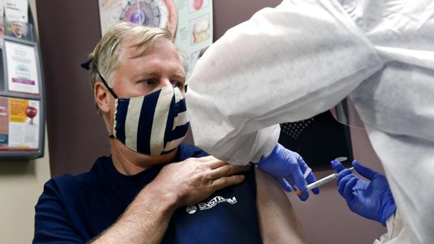 A nurse gives a volunteer an injection as the world's biggest study of a possible Covid-19 vaccine, developed by the National Institutes of Health and Moderna Inc., got underway Monday, July 27, 2020.(AP) A nurse gives a volunteer an injection as the world's biggest study of a possible Covid-19 vaccine, developed by the National Institutes of Health and Moderna Inc., got underway Monday, July 27, 2020.(AP)
