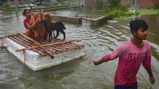 A man pulls a makeshift raft through floodwaters, with a family member and livestock on it in Muzaffarpur district, Bihar on July 26. The flood situation in the states of Assam and Bihar remains severe as rivers continue to remain in spate. Floodwaters have entered new areas across the two states, bulletins from their state disaster management authorities said on July 27. (PTI)