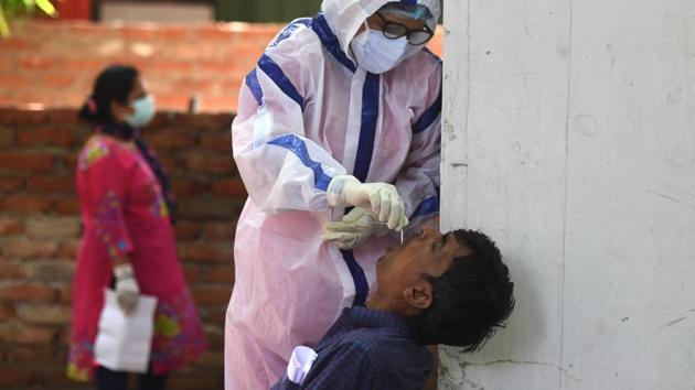 A health worker collects a swab sample for rapid antigen testing at Aruna Asaf Ali Hospital in New Delhi on July 27. A serological survey involves randomised sampling of people from whom blood is collected to check for antibodies to the Sars-Cov-2, which would indicate how many people may have been infected and silently recovered – and thus immune to the disease for the time being. (Sonu Mehta / HT Photo) A health worker collects a swab sample for rapid antigen testing at Aruna Asaf Ali Hospital in New Delhi on July 27. A serological survey involves randomised sampling of people from whom blood is collected to check for antibodies to the Sars-Cov-2, which would indicate how many people may have been infected and silently recovered – and thus immune to the disease for the time being. (Sonu Mehta / HT Photo)