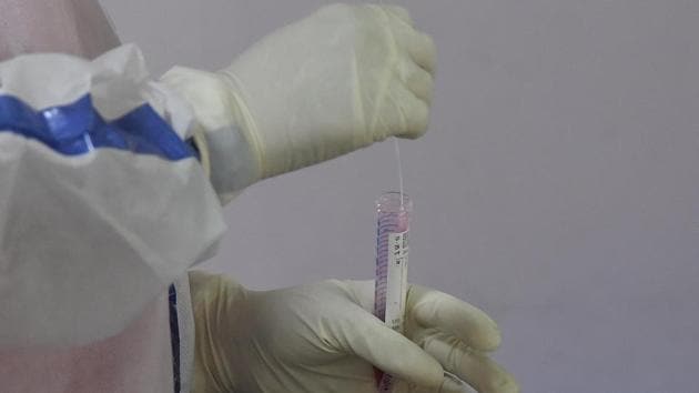 A health worker in a PPE kit handles a swab sample taken for coronavirus testing at Aruna Asaf Ali Hospital in New Delhi on July 27. According to the Union Health Ministry’s numbers, 1.48 million of India’s 1.3 billion people have been infected with coronavirus in so far. (Sonu Mehta / HT Photo)