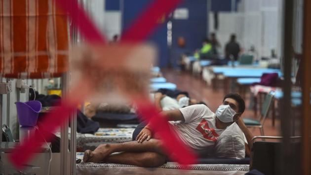 A Covid-19 patient watches television at the CWG Covid-19 Care Centre on July 24. Last week, health minister Satyendar Jain told HT the government’s plan was to ensure that the city had thrice the number of beds as active infections ready for surge preparedness. “We are comfortable at the moment; if we scale down and then the cases start rising again, what will we do? Scaling back up is easier said than done. So, we need to wait and watch,” he said. (Sanchit Khanna / HT Photo) A Covid-19 patient watches television at the CWG Covid-19 Care Centre on July 24. Last week, health minister Satyendar Jain told HT the government’s plan was to ensure that the city had thrice the number of beds as active infections ready for surge preparedness. “We are comfortable at the moment; if we scale down and then the cases start rising again, what will we do? Scaling back up is easier said than done. So, we need to wait and watch,” he said. (Sanchit Khanna / HT Photo)