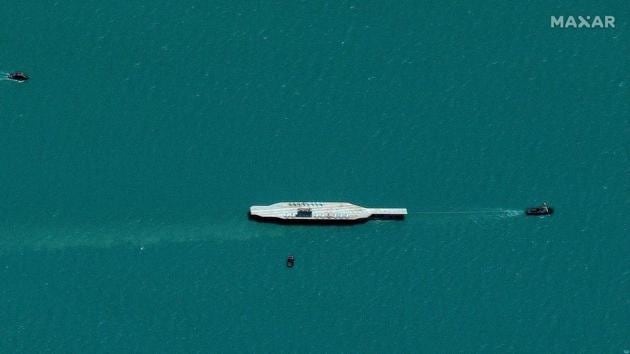 Iran's refurbished mockup aircraft carrier is seen towed by a tugboat near Bandar Abbas.(Reuters) Iran's refurbished mockup aircraft carrier is seen towed by a tugboat near Bandar Abbas.(Reuters)