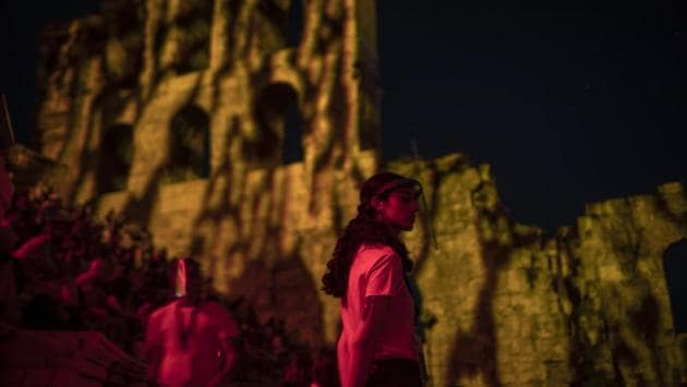 Stewards wearing plastic visors stand at the Odeon of Herodes Atticus in Athens, during a concert on Wednesday, July 15, 2020. (AP Photo/Petros Giannakouris) Stewards wearing plastic visors stand at the Odeon of Herodes Atticus in Athens, during a concert on Wednesday, July 15, 2020. (AP Photo/Petros Giannakouris)