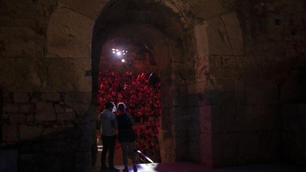 A Steward wearing a plastic visor stands at a gate of the Odeon of Herodes Atticus in Athens, during a concert on Wednesday, July 15, 2020. (AP Photo/Petros Giannakouris) A Steward wearing a plastic visor stands at a gate of the Odeon of Herodes Atticus in Athens, during a concert on Wednesday, July 15, 2020. (AP Photo/Petros Giannakouris)