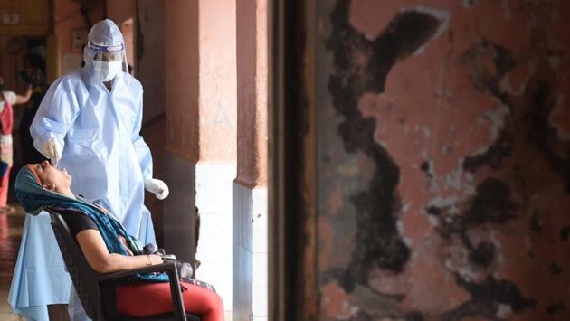 A Brihanmumbai Municipal Corporation (BMC) health care worker collects swab sample from a woman to test for Covid-19 infection at Anushakti Nagar in Mumbai on July 28. Maharashtra continues to grapple with the highest Covid-19 casualties across India, apart from having the largest number of infections. (Satish Bate / HT Photo)