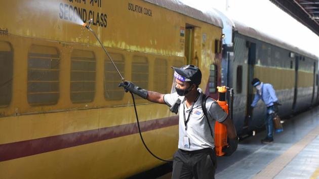 A worker chemically disinfects a train coach.(Raj K Raj/HT PHOTO)