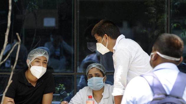 A health worker registers people for coronavirus test, at Sector 30 District Hospital, in Noida. (Sunil Ghosh / Hindustan Times) A health worker registers people for coronavirus test, at Sector 30 District Hospital, in Noida. (Sunil Ghosh / Hindustan Times)