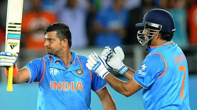 India's Suresh Raina waves his bat as his captain MS Dhoni watches after scoring a century while batting against Zimbabwe during their Cricket World Cup Pool B match.(AP)