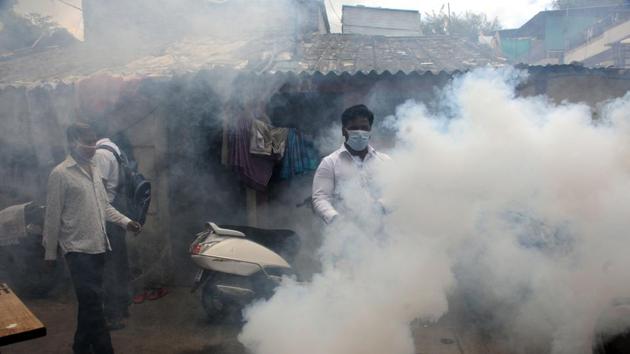 Shiv Sena workers fumigate houses in Gokhale Nagar, Pune on July 27. Maharashtra’s active case tally stands at 144,694, with 10,333 patients being discharged on July 28. So far, 232,277 people have recovered in the state, HT reported. (HT Photo)