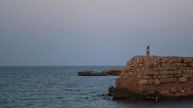 A couple embraces on the top of an ancient wall, after Catalonia's regional authorities announced restrictions to contain the spread of the coronavirus disease (COVID-19), in Sant Marti d'Empuries, near Figueres, Costa Brava, Spain July 28, 2020. (REUTERS) A couple embraces on the top of an ancient wall, after Catalonia's regional authorities announced restrictions to contain the spread of the coronavirus disease (COVID-19), in Sant Marti d'Empuries, near Figueres, Costa Brava, Spain July 28, 2020. (REUTERS)
