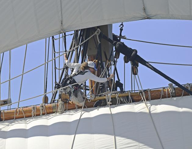 Crew member Sarah Clement loosens a stuck line as the Mayflower II sets sail in the waters of Fishers Island Sound off Groton, Conn., Tuesday, July 28, 2020, on the seventh day of two weeks of sea trials. (AP) Crew member Sarah Clement loosens a stuck line as the Mayflower II sets sail in the waters of Fishers Island Sound off Groton, Conn., Tuesday, July 28, 2020, on the seventh day of two weeks of sea trials. (AP)