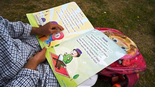 A student attends a class at an open-air school in Doodhpathri on July 27.The opening of schools in India, now the third most infected nation in the world--with over 1.5 million infections--it is not yet clear. (Tauseef Mustafa / AFP)
