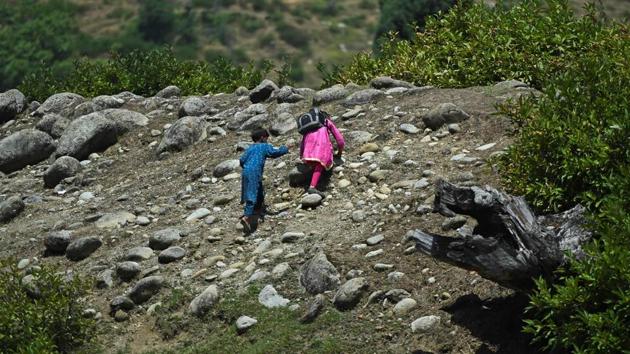 Children climb up a hill towards their open-air school which is situated on top of a mountain in Doodhpathri, on July 28. The relief is obvious to everyone involved in the classes held at an altitude of 2,730 metres (9,000 feet). (Tauseef Mustafa / AFP)