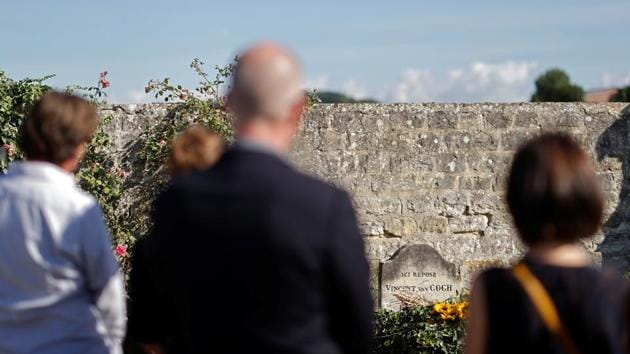 People stand in front of the grave of Vincent van Gogh during a ceremony marking his 130th death anniversary at the cemetery in Auvers-sur-Oise on July 29. Dutch researcher Van der Veen told Reuters that early this year he had received a large collection of early 20th-century postcards from a 94-year-old woman in Auvers village. (Christian Hartmann / REUTERS) People stand in front of the grave of Vincent van Gogh during a ceremony marking his 130th death anniversary at the cemetery in Auvers-sur-Oise on July 29. Dutch researcher Van der Veen told Reuters that early this year he had received a large collection of early 20th-century postcards from a 94-year-old woman in Auvers village. (Christian Hartmann / REUTERS)