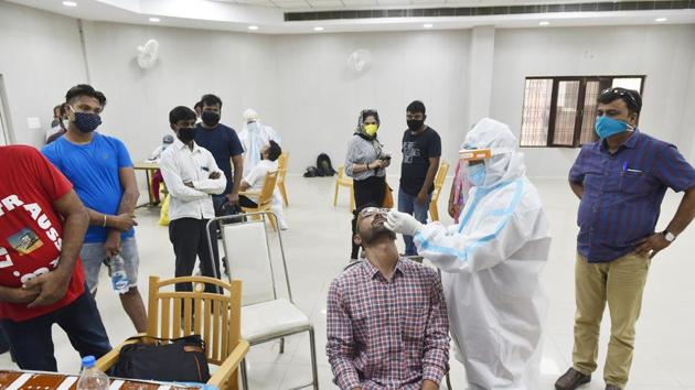 A health worker in PPE coveralls takes a swab sample for coronavirus testing, at Kalyan Mandap, in Lucknow, Uttar Pradesh, July 30, 2020. (HT Photo) A health worker in PPE coveralls takes a swab sample for coronavirus testing, at Kalyan Mandap, in Lucknow, Uttar Pradesh, July 30, 2020. (HT Photo)