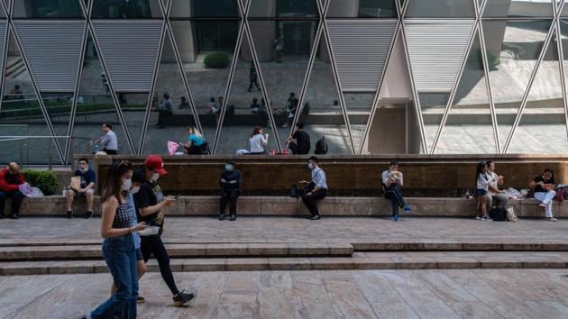 People eat their takeout meals in a public square during lunch hour in Sheung Wan district in Hong Kong, China.(Bloomberg) People eat their takeout meals in a public square during lunch hour in Sheung Wan district in Hong Kong, China.(Bloomberg)